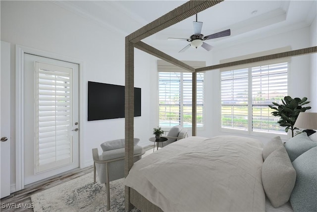 bedroom featuring wood-type flooring, ornamental molding, and ceiling fan