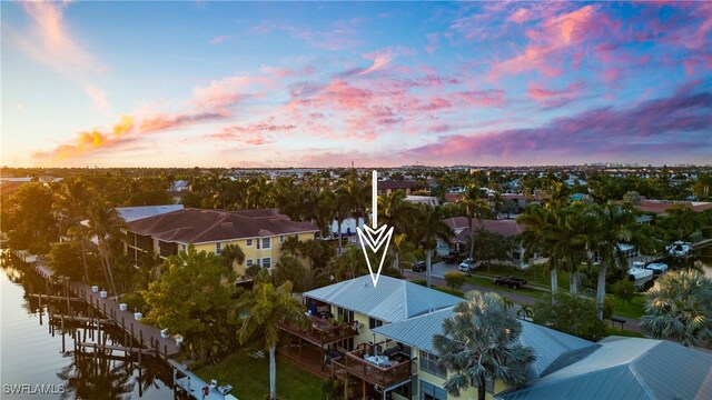 aerial view at dusk with a water view