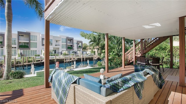 deck featuring a water view, outdoor lounge area, and a dock