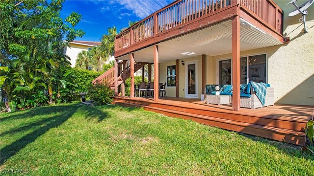 rear view of house featuring a deck, a yard, and outdoor lounge area