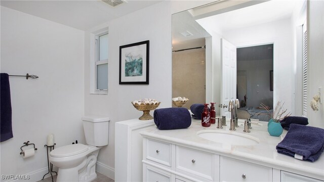 bathroom with vanity and toilet