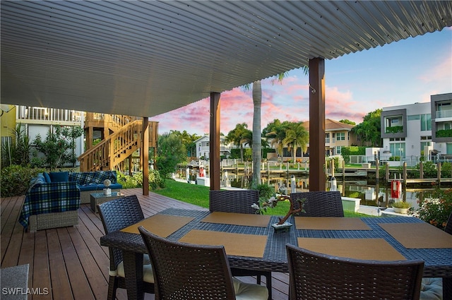 deck at dusk featuring a water view and an outdoor hangout area