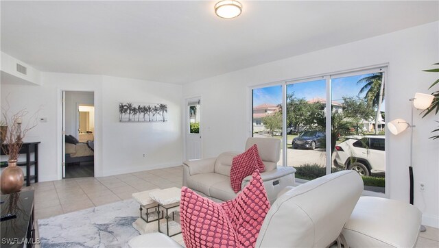 tiled living room featuring a healthy amount of sunlight