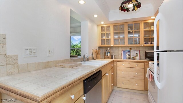 kitchen with sink, ornamental molding, white appliances, backsplash, and tile countertops