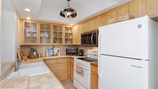 kitchen featuring hanging light fixtures, white appliances, a tray ceiling, light brown cabinetry, and sink