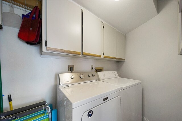 laundry room featuring cabinets and washing machine and dryer