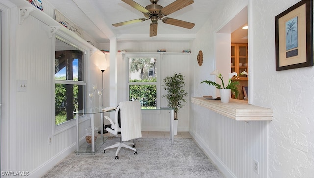 tiled office space with ceiling fan and a healthy amount of sunlight