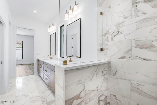 bathroom featuring a tile shower and vanity