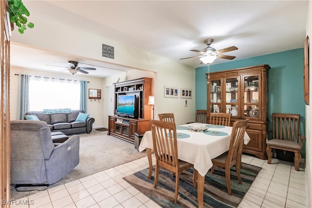 carpeted dining area with ceiling fan