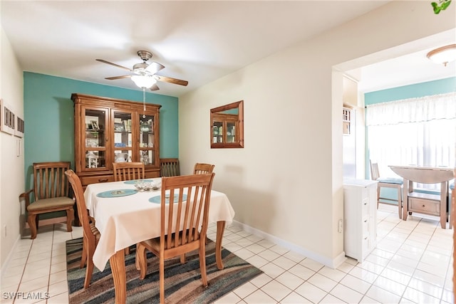 tiled dining space featuring ceiling fan