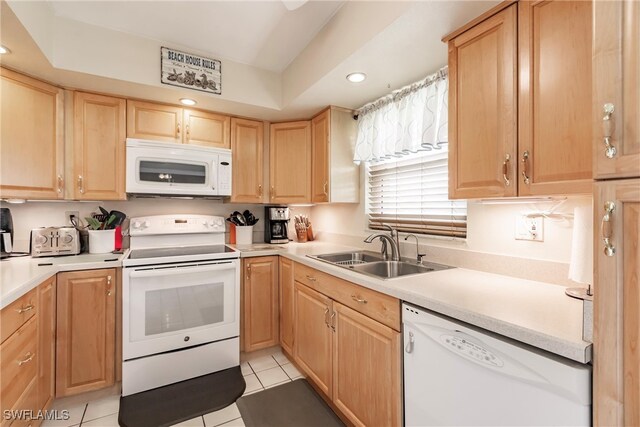 kitchen featuring light brown cabinets, light tile patterned flooring, sink, and white appliances