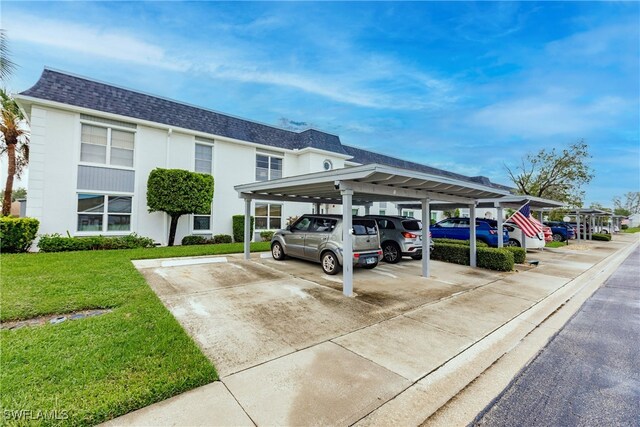 exterior space with a lawn and a carport