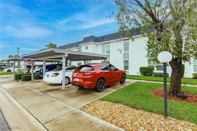 view of front of house featuring a carport and a front lawn