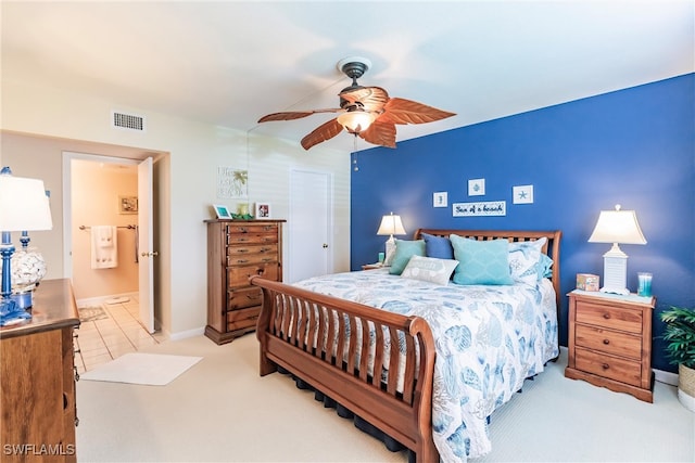 carpeted bedroom with ceiling fan and ensuite bathroom