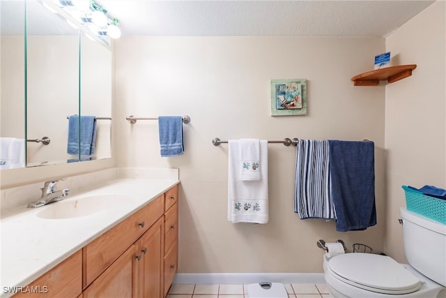 bathroom featuring tile patterned floors, a textured ceiling, vanity, and toilet