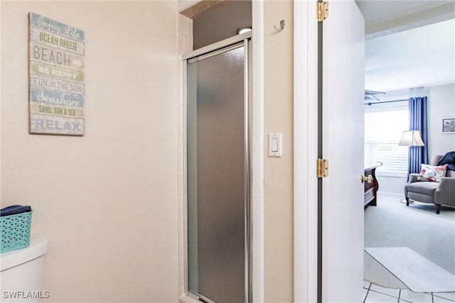 bathroom with an enclosed shower and toilet