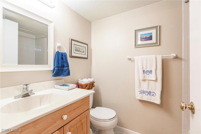 bathroom featuring walk in shower, vanity, toilet, and a textured ceiling