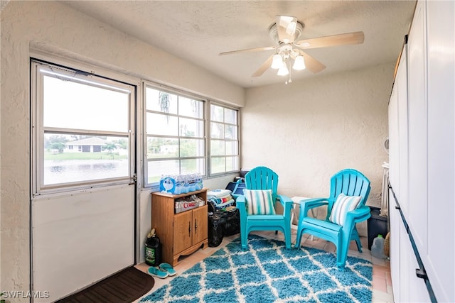 living area with ceiling fan