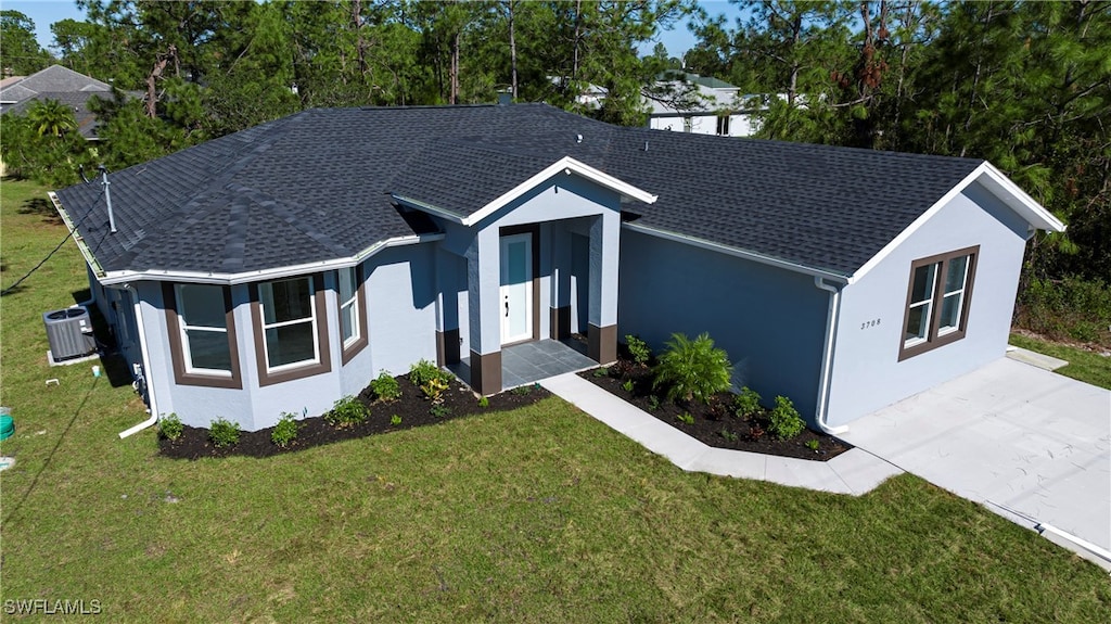 single story home with central AC unit and a front lawn