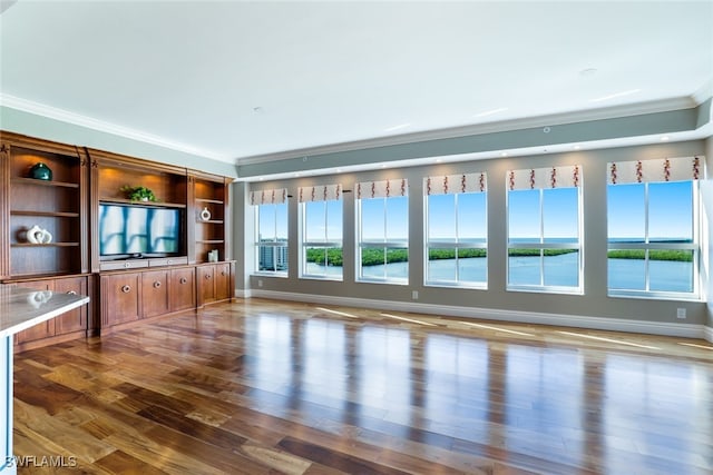 unfurnished living room with ornamental molding, hardwood / wood-style floors, and a water view