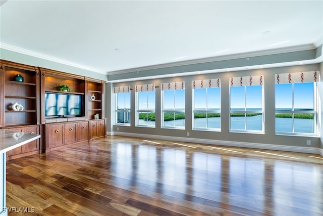 295 Grande Way Unit 1004, Naples, FL 34110 - unfurnished living room featuring ornamental molding, plenty of natural light, and wood finished floors
