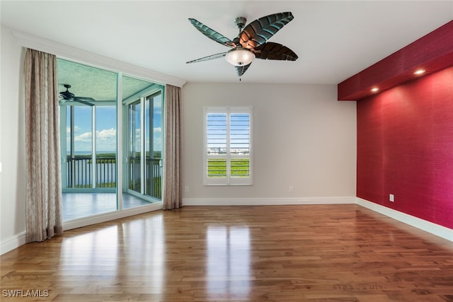 empty room with wood-type flooring and ceiling fan