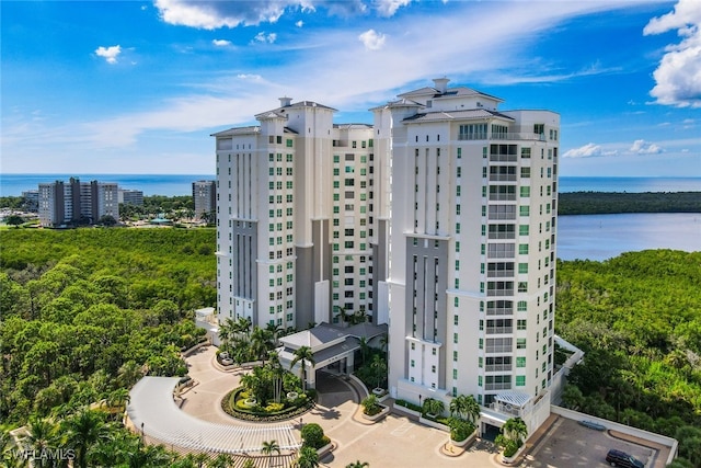 view of building exterior with a city view and a water view