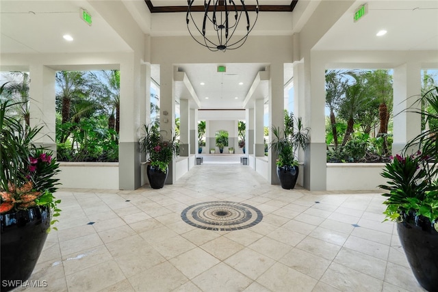 295 Grande Way Unit 1004, Naples, FL 34110 - tiled entrance foyer featuring a chandelier, crown molding, plenty of natural light, a high ceiling, and recessed lighting