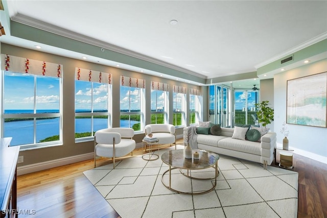 sunroom / solarium featuring visible vents and a water view