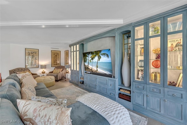 home theater room featuring light wood-type flooring and ornamental molding