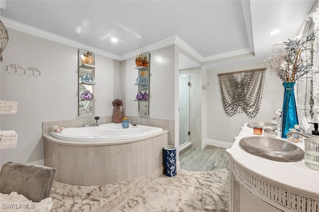 bathroom featuring crown molding, vanity, wood-type flooring, and plus walk in shower