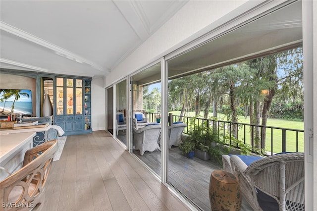 sunroom featuring lofted ceiling