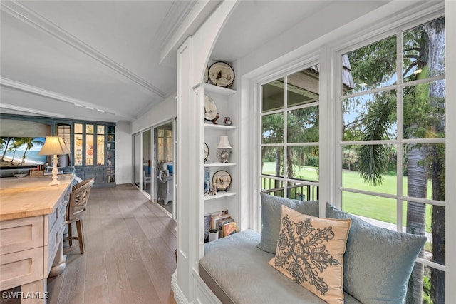 sunroom / solarium with vaulted ceiling with beams