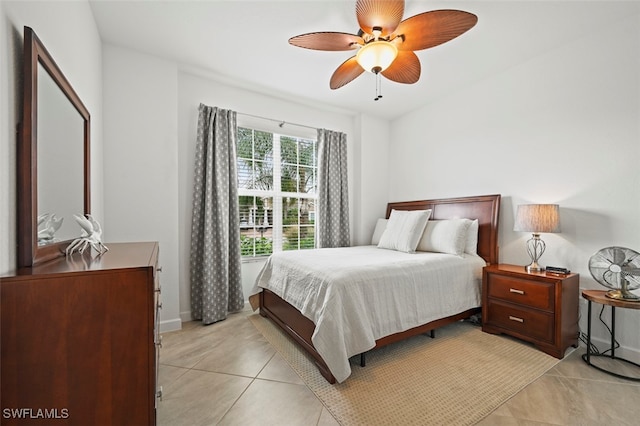 bedroom featuring ceiling fan, baseboards, and light tile patterned floors