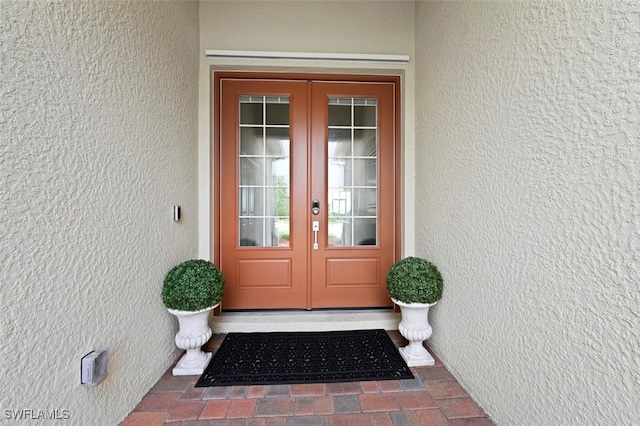 doorway to property with french doors and stucco siding