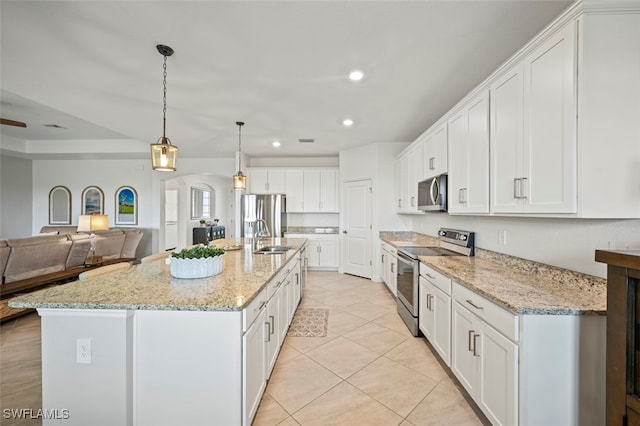 kitchen with open floor plan, white cabinetry, stainless steel appliances, and recessed lighting