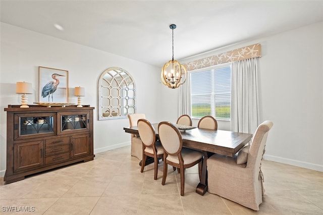 dining room with baseboards, light tile patterned floors, and an inviting chandelier