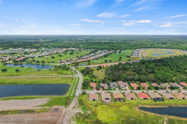 drone / aerial view featuring a residential view and a water view