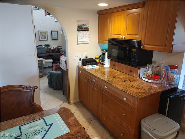 kitchen featuring stone countertops and light tile patterned floors