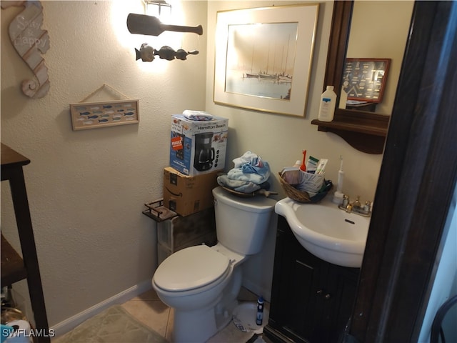 bathroom with vanity, toilet, and tile patterned floors