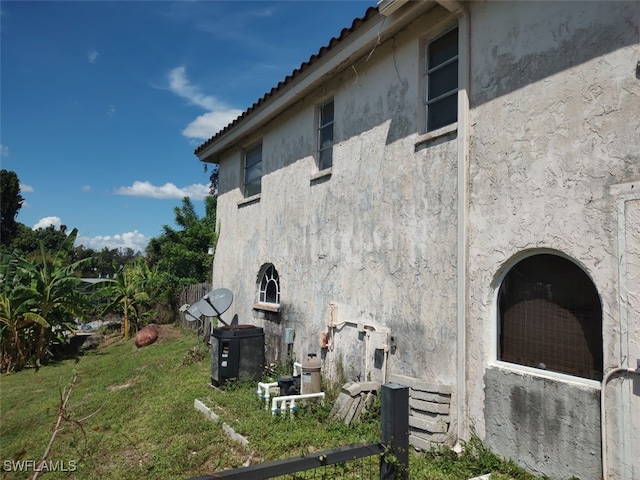 view of property exterior with a lawn