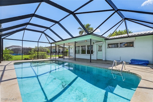 view of swimming pool featuring a lanai, a patio, and ceiling fan