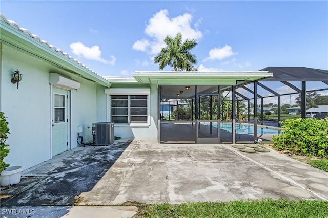 exterior space with central AC unit and a patio