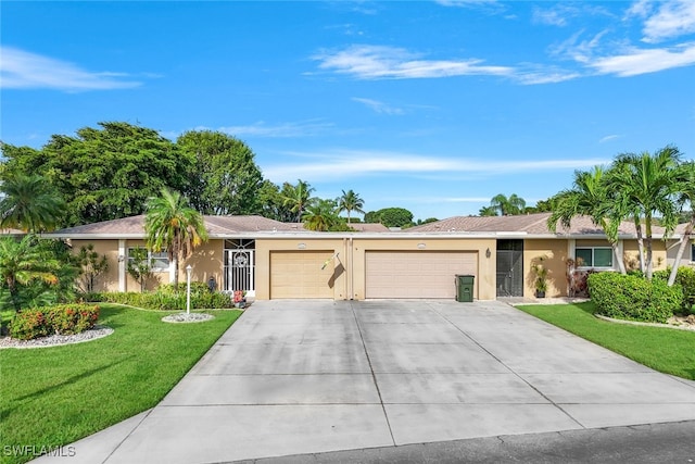 ranch-style house with a garage and a front lawn