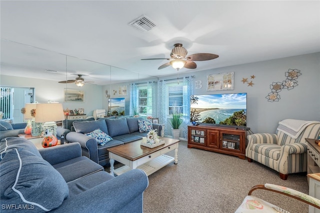 carpeted living room with ceiling fan