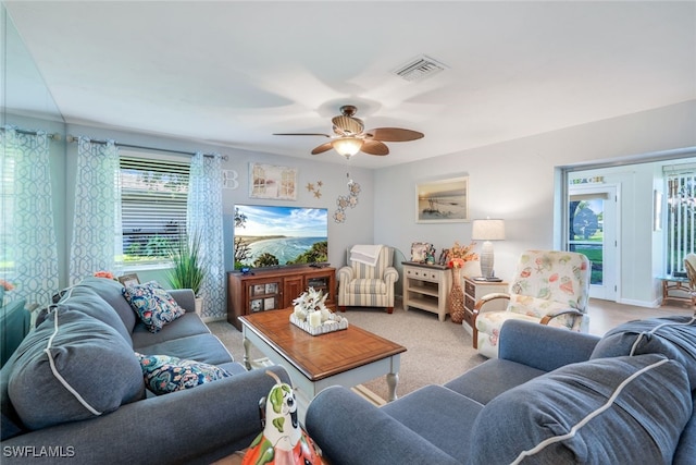 living room featuring carpet flooring and ceiling fan