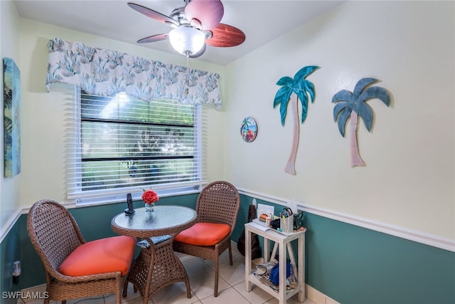 tiled dining space with ceiling fan