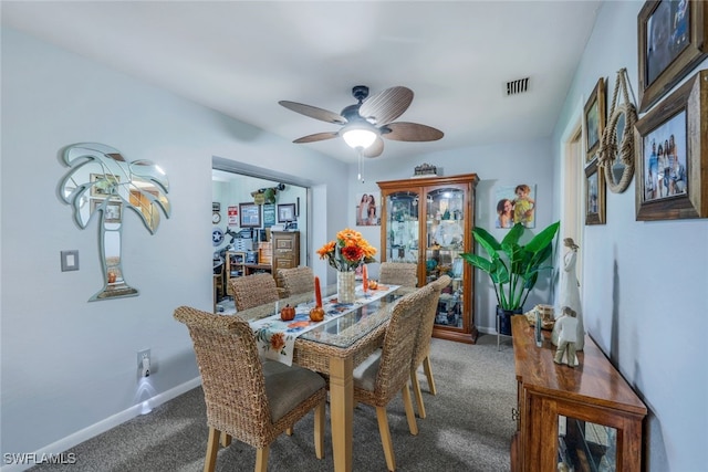 dining area featuring ceiling fan and carpet