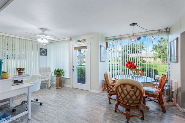 interior space with wood-type flooring and ceiling fan