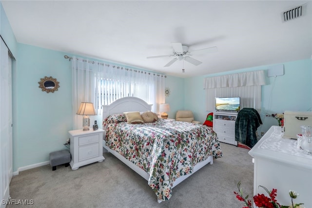 carpeted bedroom featuring ceiling fan and a closet